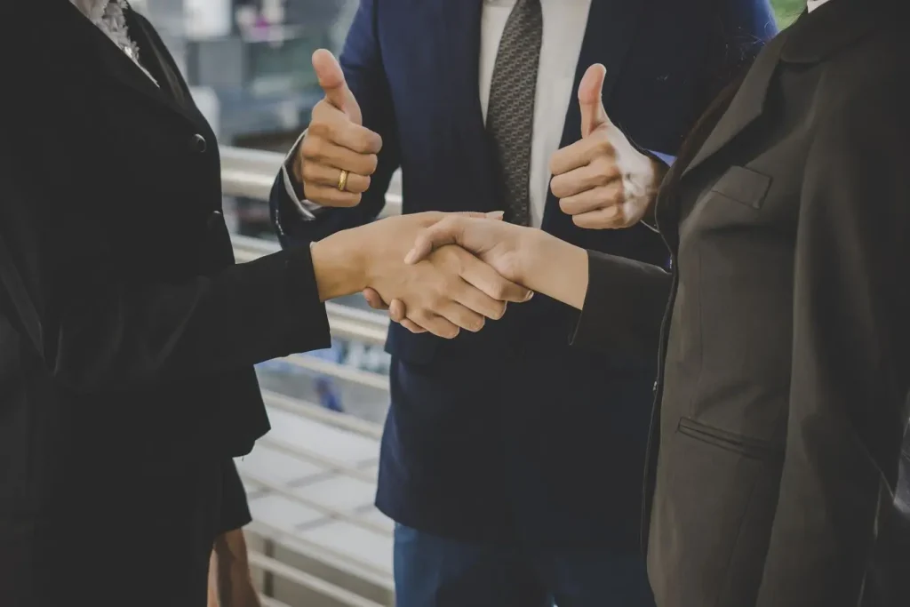 business people shaking hands finishing up meeting deals business concept 1150 2981
