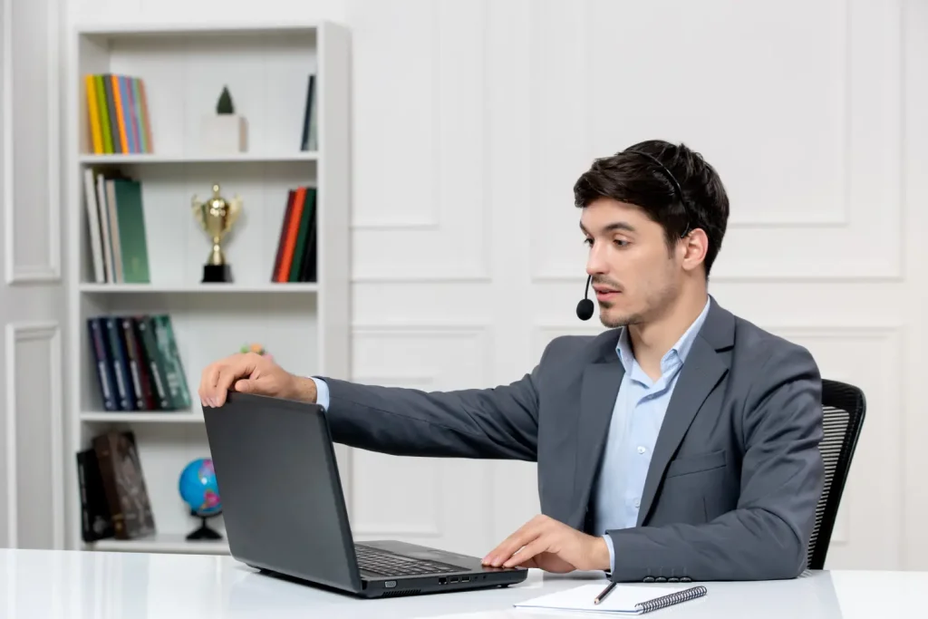Dedicated Resources 2 customer service cute guy grey suit with computer headset ending videocall