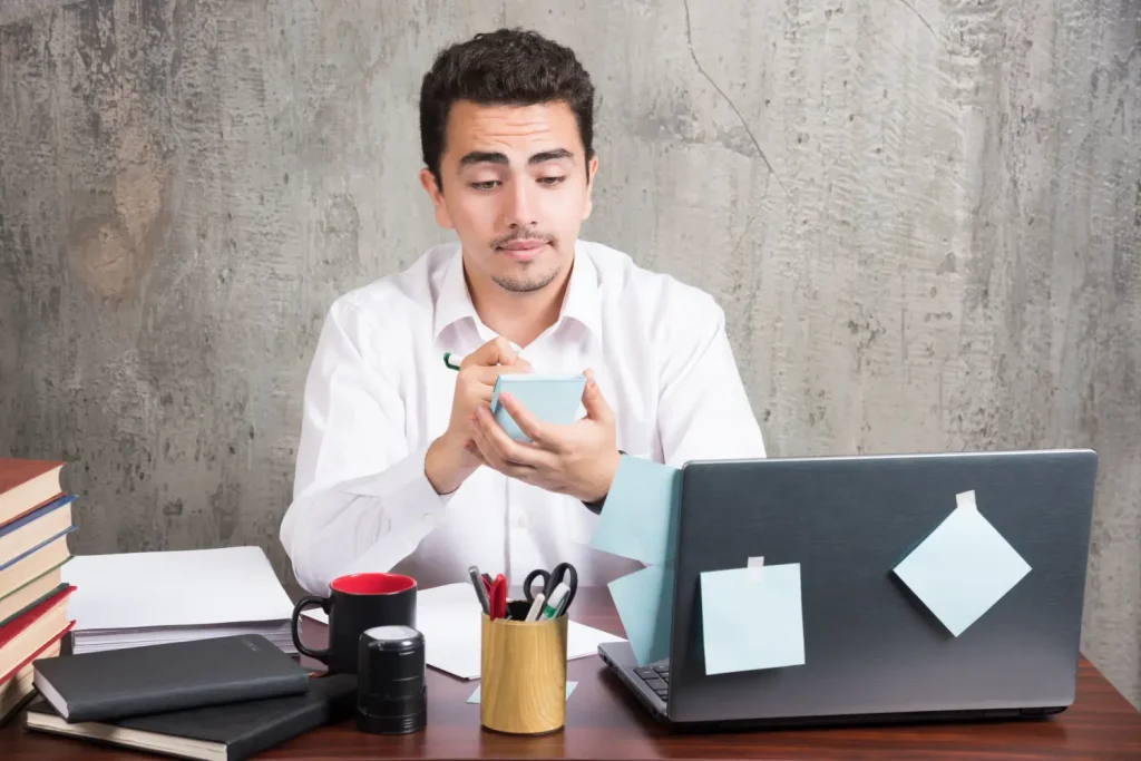 Dedicated Resources 1 office employee looking his telephone office desk